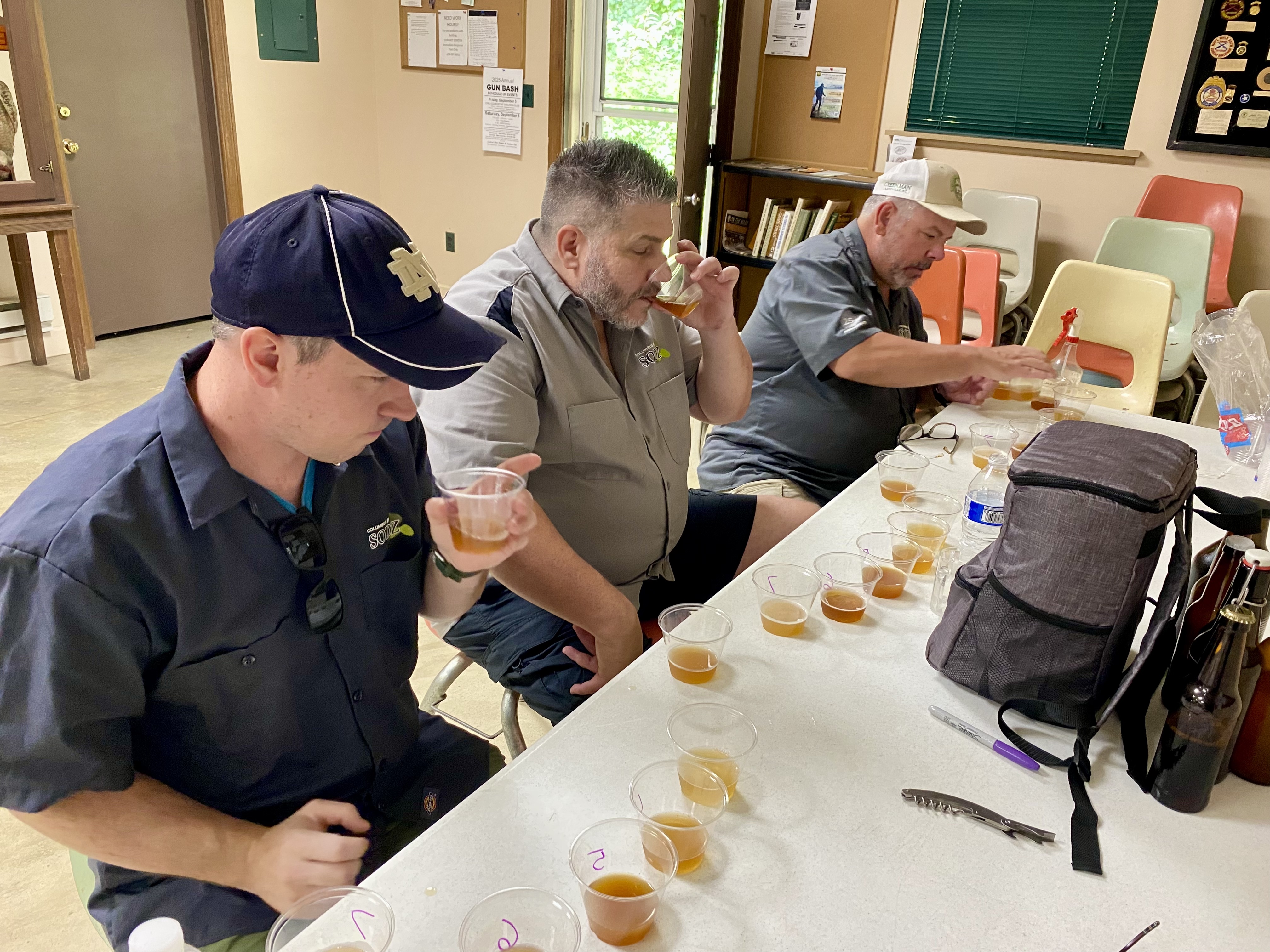 Three beer judges sampling beers